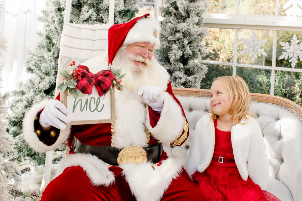 Santa smiles at a little girl at her Christmas mini-session at Prospect Farms in lawrenceville
